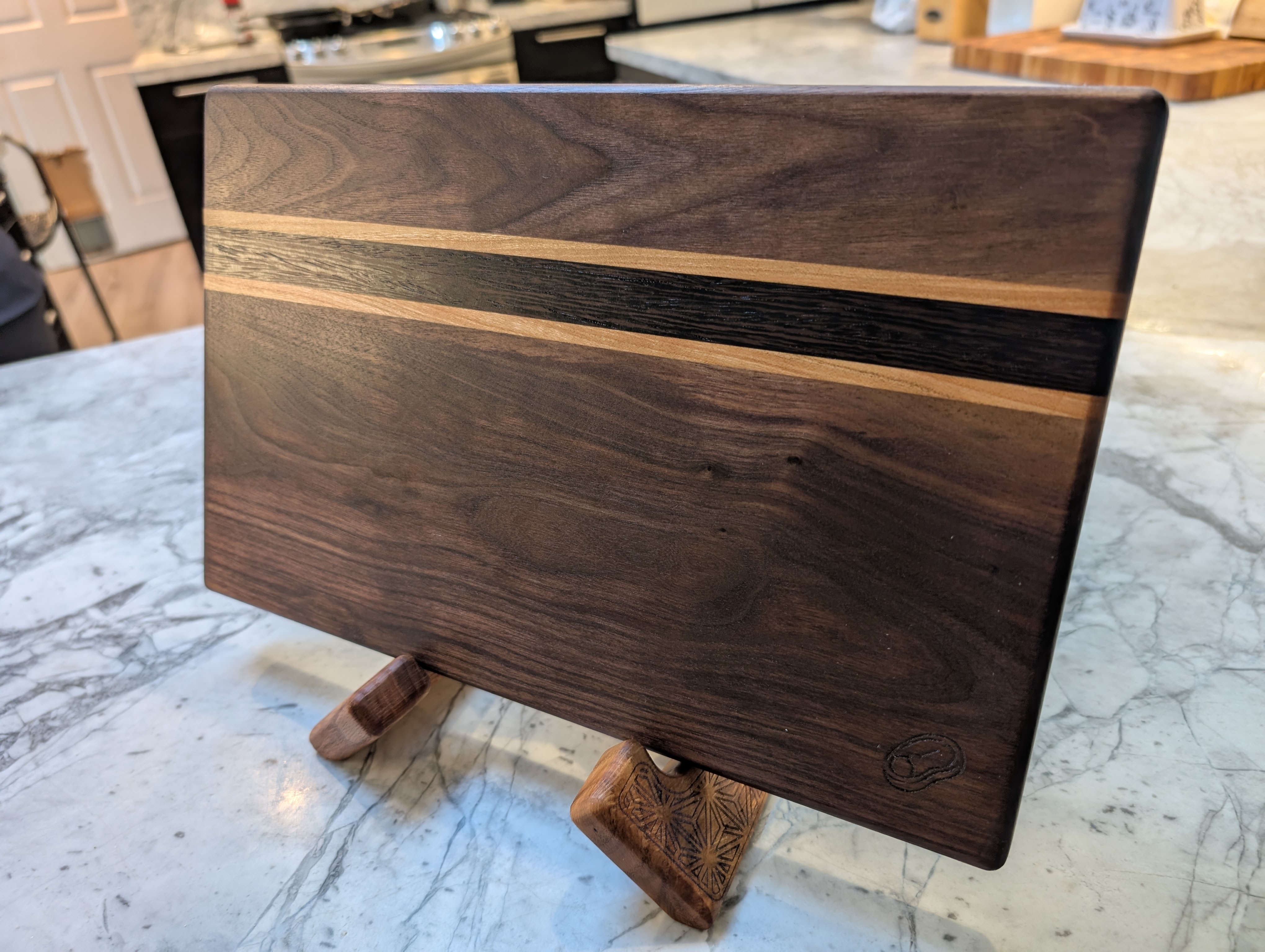 Striped walnut cutting board, side angle
